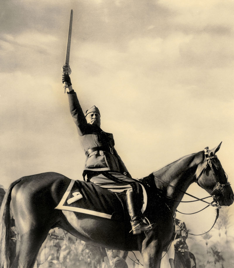 "Il Duce" Benito Mussolini on horseback holding the sword of Islam, Tripoli. Retouched04/1937