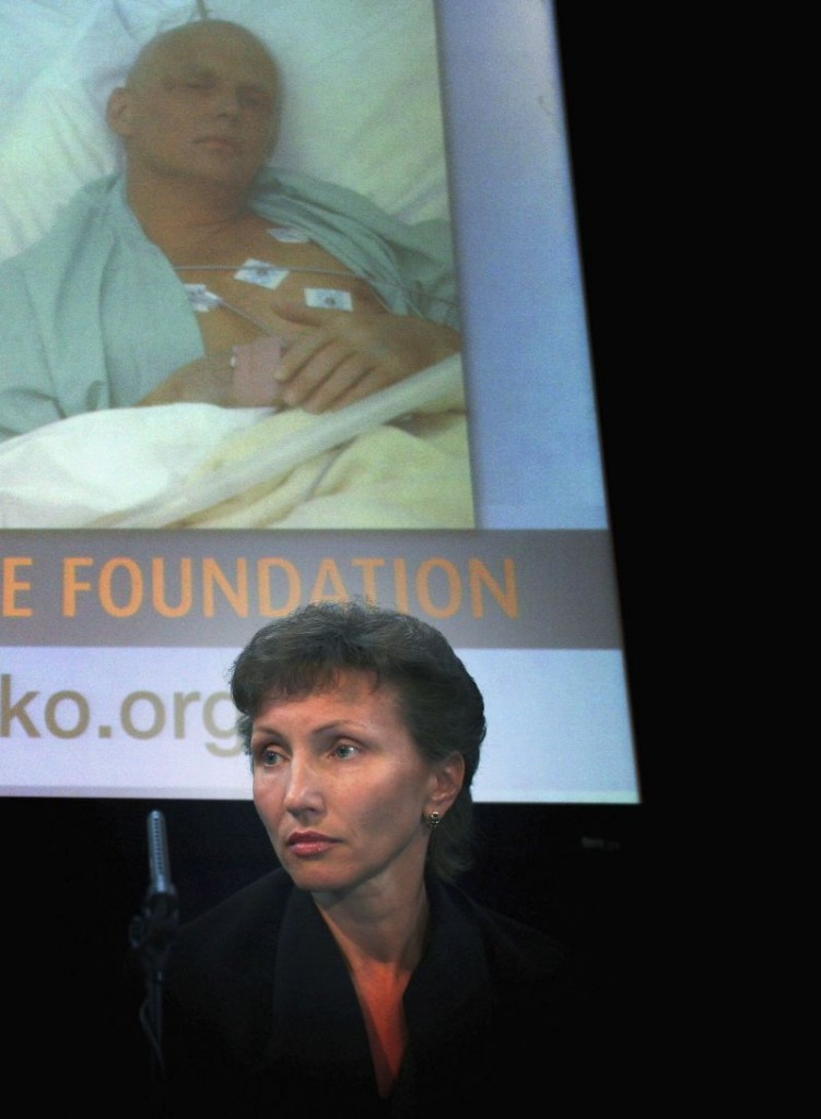 LONDON - APRIL 03: Marina Litvinenko, the widow of murdered former spy Alexander Litvinenko, sits under a image of her deceased husband at the launch of Alexander Litvinenko Foundation at the Royal United Services Institutes on April 3, 2007 in London, England. Marina Litvinenko, together with close friend Alex Goldfarb and Russian billionaire Boris Berezovsky, are setting the foundation up to aid the investigation into Mr Litvinenko's death. (Photo by Matt Cardy/Getty Images)