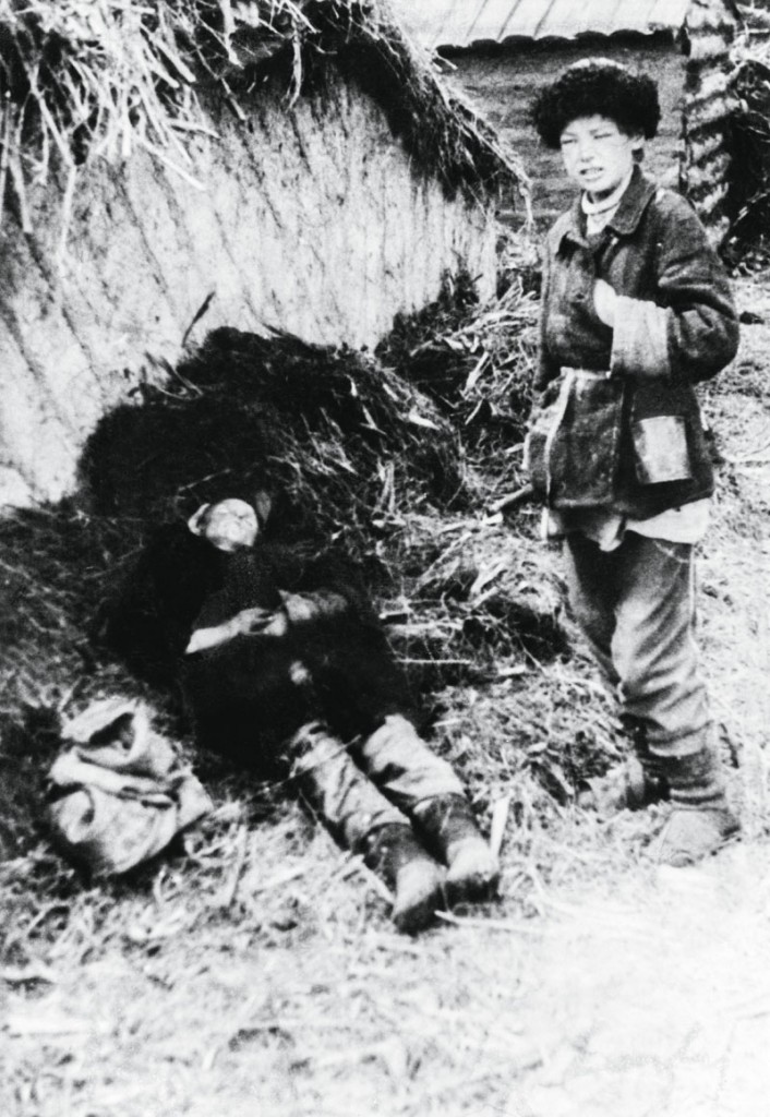 A boy next to the body of his father after the man was shot for approaching a prohibited area of a farm while picking grain during the man-made Holodomor famine in the Ukraine, Belgorod, former Soviet Union, 1934. (Photo by Daily Express/Hulton Archive/Getty Images)